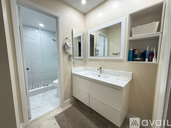 A bathroom with a white sink and a mirror above it.