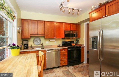 A kitchen with wooden cabinets and stainless steel appliances.