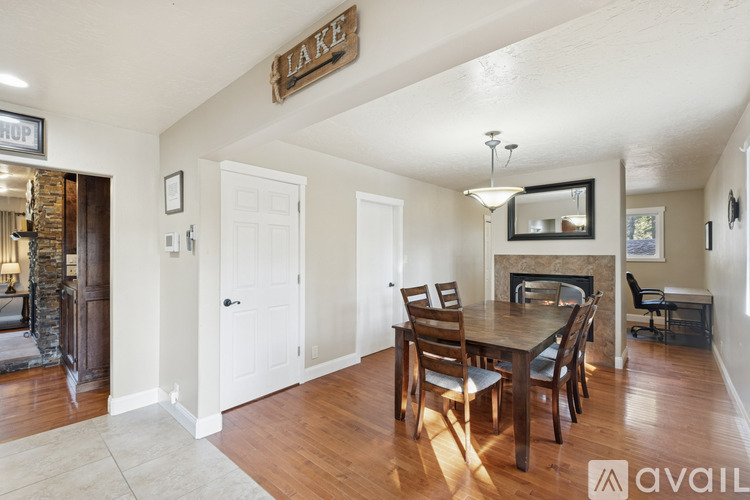 A dining room with a wooden table and chairs.