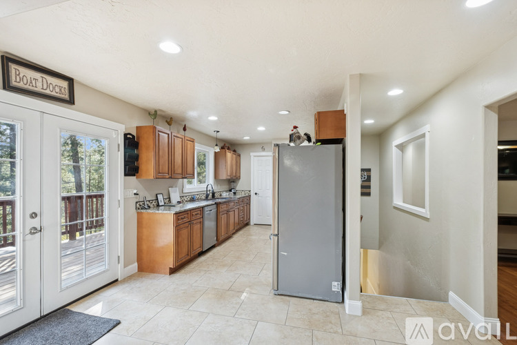 A kitchen with a refrigerator in the middle of the room.