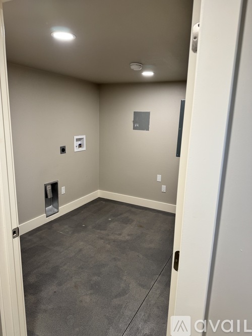 A room with a door and a wall socket.