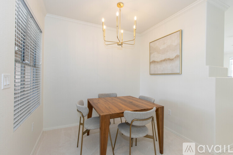 A dining room with a wooden table and chairs.