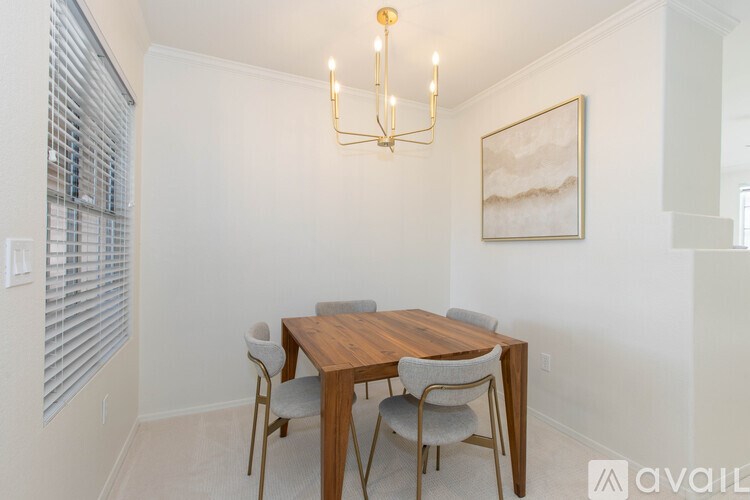 A dining room with a wooden table and chairs.
