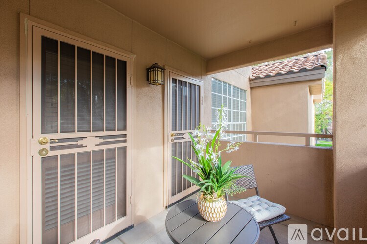A table with a pineapple on it sits on a balcony.