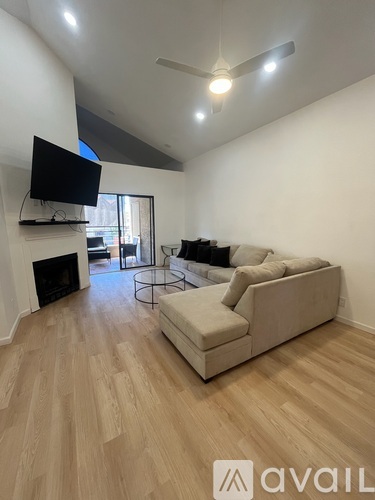 A living room with a television, a fireplace, and a couch.
