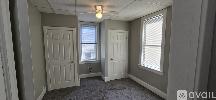 A room with two doors and a window.