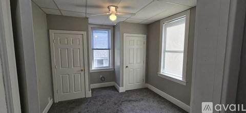 A room with two doors and a window.