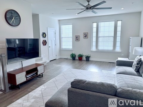 A living room with a grey couch and a television.