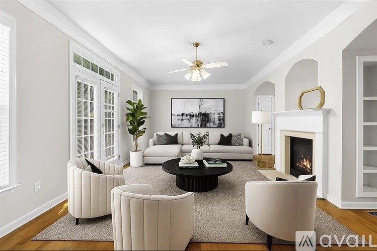 A living room with a fireplace and a painting on the wall.