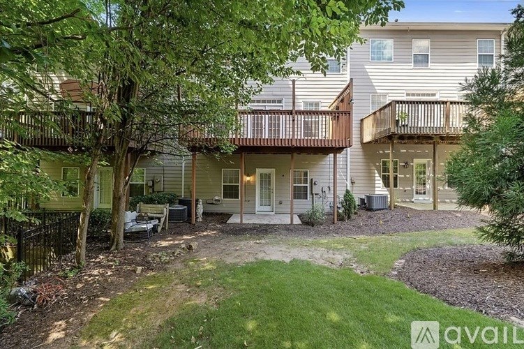 A tree is in front of a house.