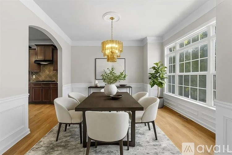 A dining room with a table set for six.