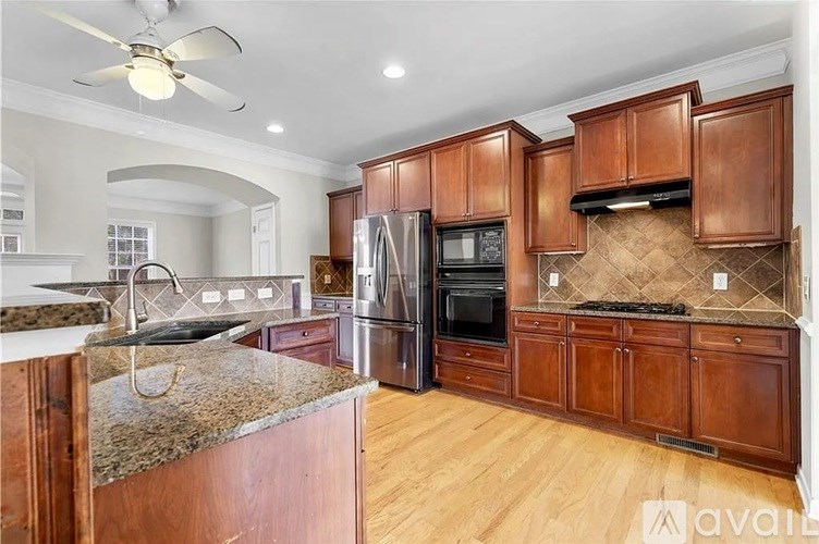 A kitchen with wooden cabinets and a granite countertop.