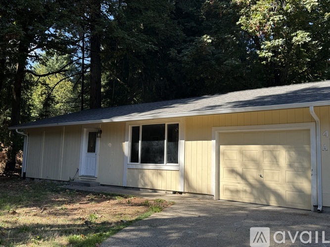 A two-car garage with a white door and a window is available for rent.