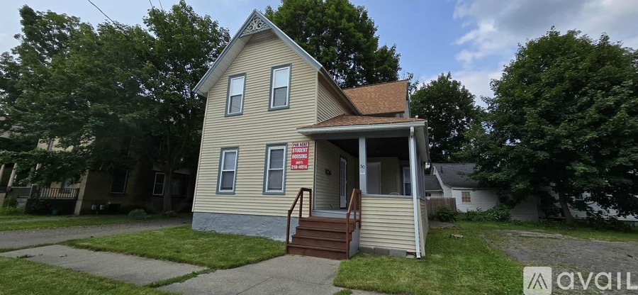 A house with a "STUDENT HOUSING" sign on the front.
