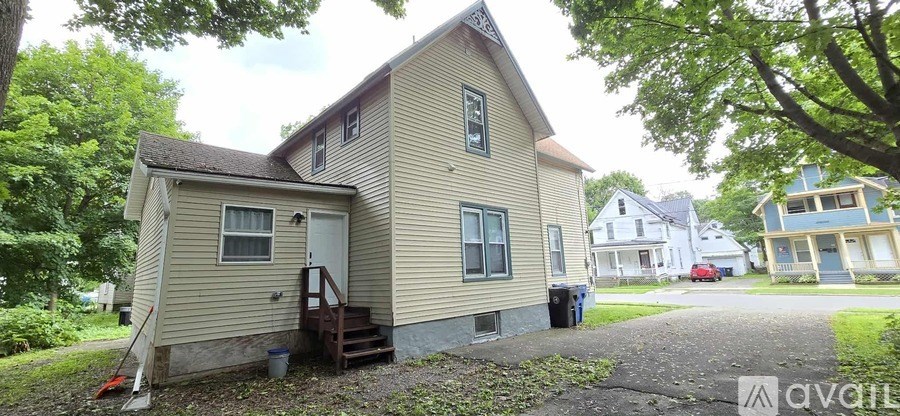A kitchen with white cabinets and black appliances.
