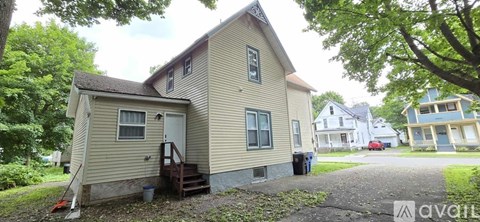 A kitchen with white cabinets and black appliances.