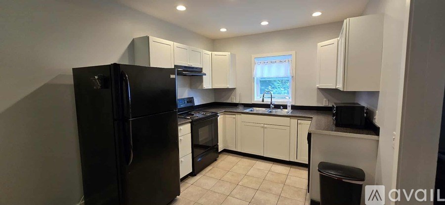 A bedroom with a bed, dresser, and wardrobe.