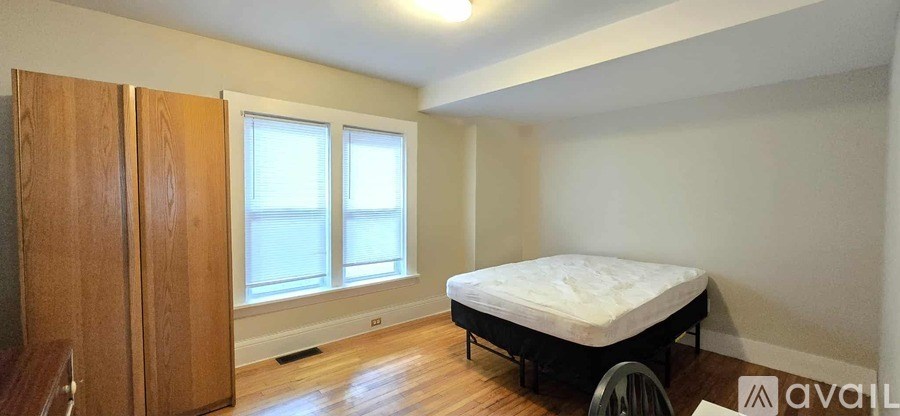 A bedroom with a bed, wardrobe and window.