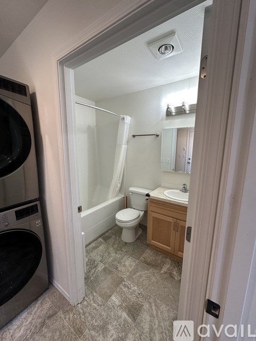 A bathroom with a toilet, sink, and shower.