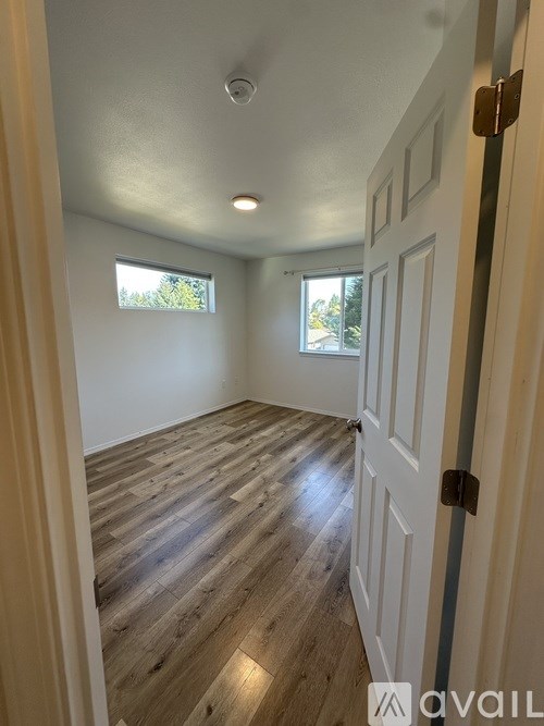 A room with wooden floors and a white door.