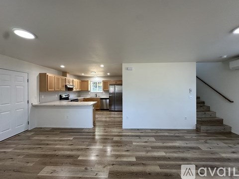 A spacious kitchen with wooden cabinets and a white countertop.