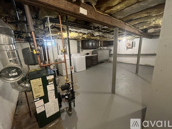 A room with a lot of pipes and a tank.