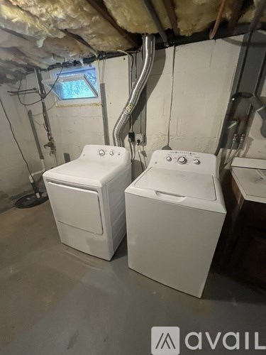 Two white toilets in a room under construction.