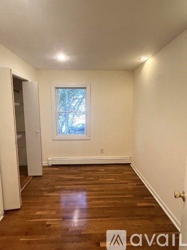 A room with wooden floors and a window.