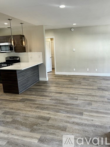 A kitchen with a counter and a stove top oven.