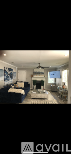 A living room with a blue couch and a television.