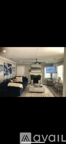 A living room with a blue couch and a television.
