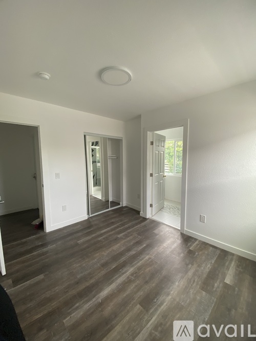 A room with wooden floors and white walls.