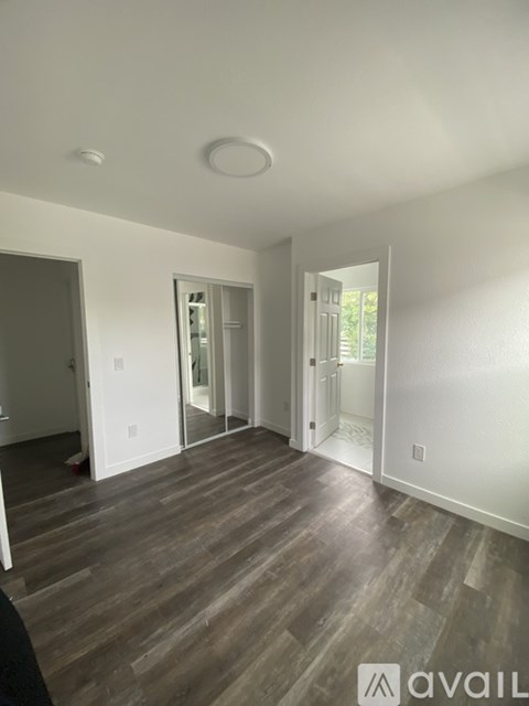 A room with wooden floors and white walls.