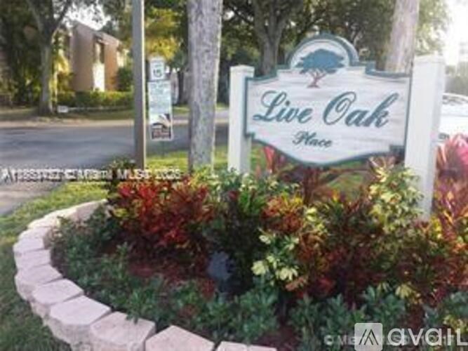 A sign that says Live Oak in front of a building.