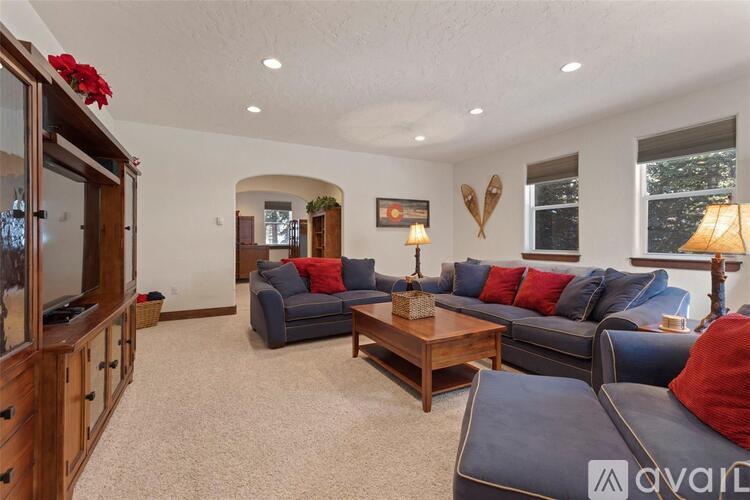 A living room with a grey couch and a wooden coffee table.