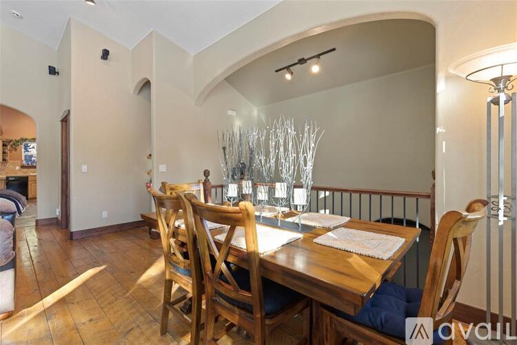 A dining room with a wooden table and chairs.
