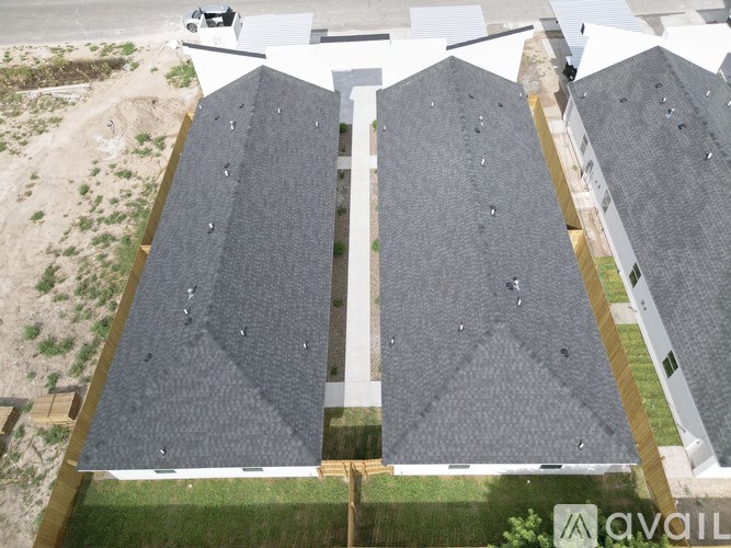 A bird's eye view of a building with grey roofs.
