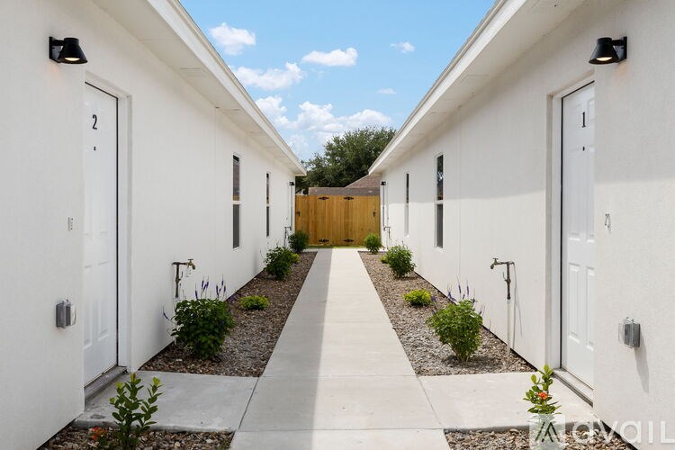 A white building with a wooden door in the middle.