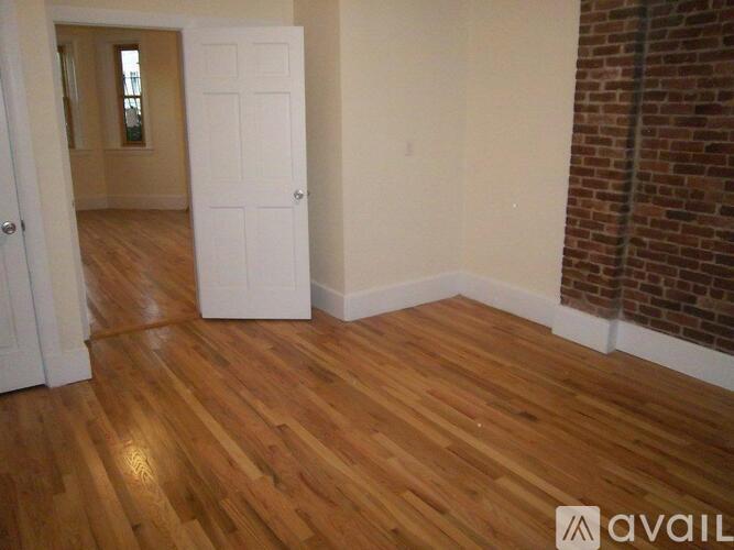 A room with wooden floors and a white door.