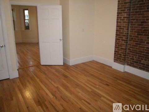 A room with wooden floors and a white door.