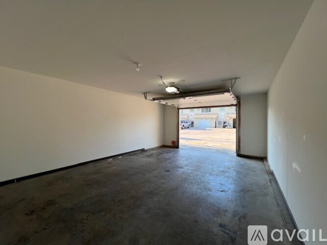 A room with a ceiling fan and carpeted floor.