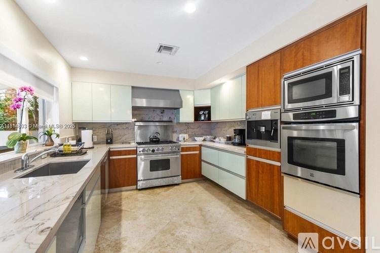 A kitchen with wooden cabinets and stainless steel appliances.