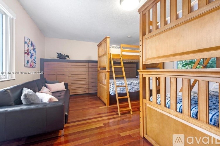 A room with a bunk bed and a couch.