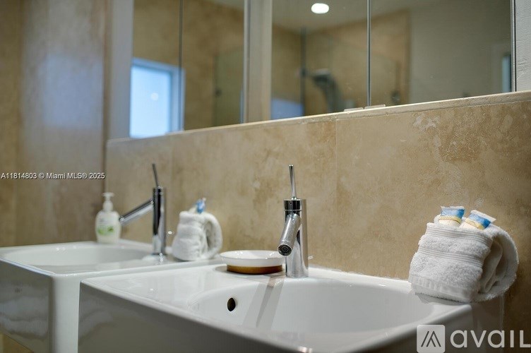 A bathroom sink with a towel and toiletries on it.