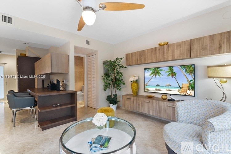 A living room with a flat screen TV mounted on the wall.
