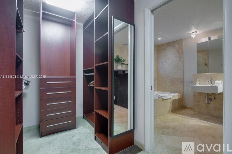 A bathroom with a walk-in shower and a vanity with a mirror.