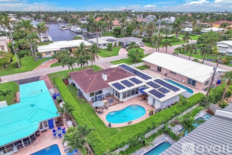 A house with a pool and solar panels on the roof.