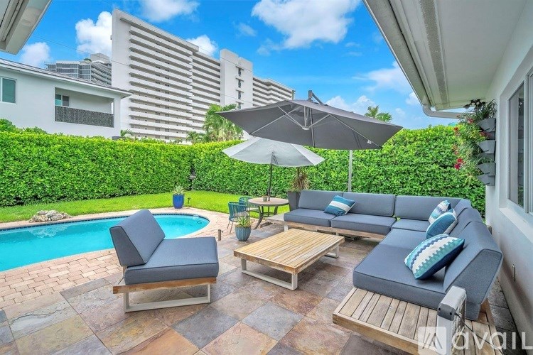 A patio with a pool and a sofa.
