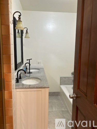 A bathroom with a sink and a mirror.