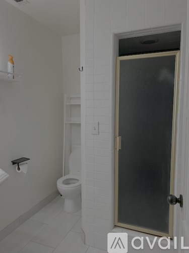 A bathroom with a toilet, sink, and a door.